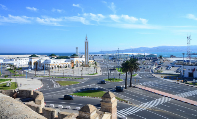 Aerial view of Tangier, Morocco, showcasing the city's blend of modern construction and traditional urban areas. The image highlights the contrast between new developments and older, densely populated neighborhoods.