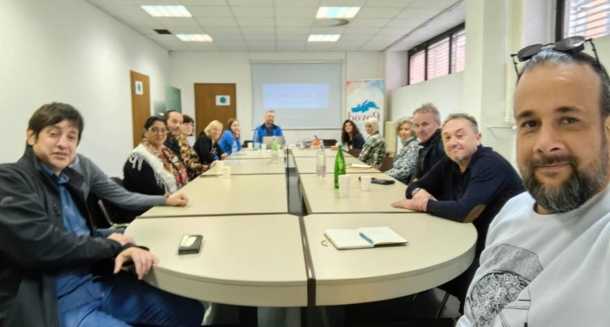 In door meeting, people sitting around the table 